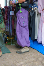 Purple Love Pants with a beaded charm on the pocket, side view