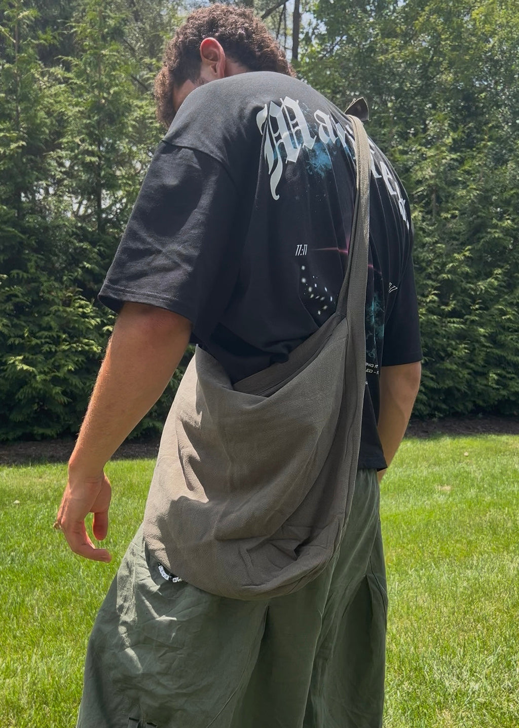 Bottomless Bag in Evergreen, worn crossbody, back view