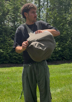 Bottomless Bag in Evergreen, stuffed full and held in both arms