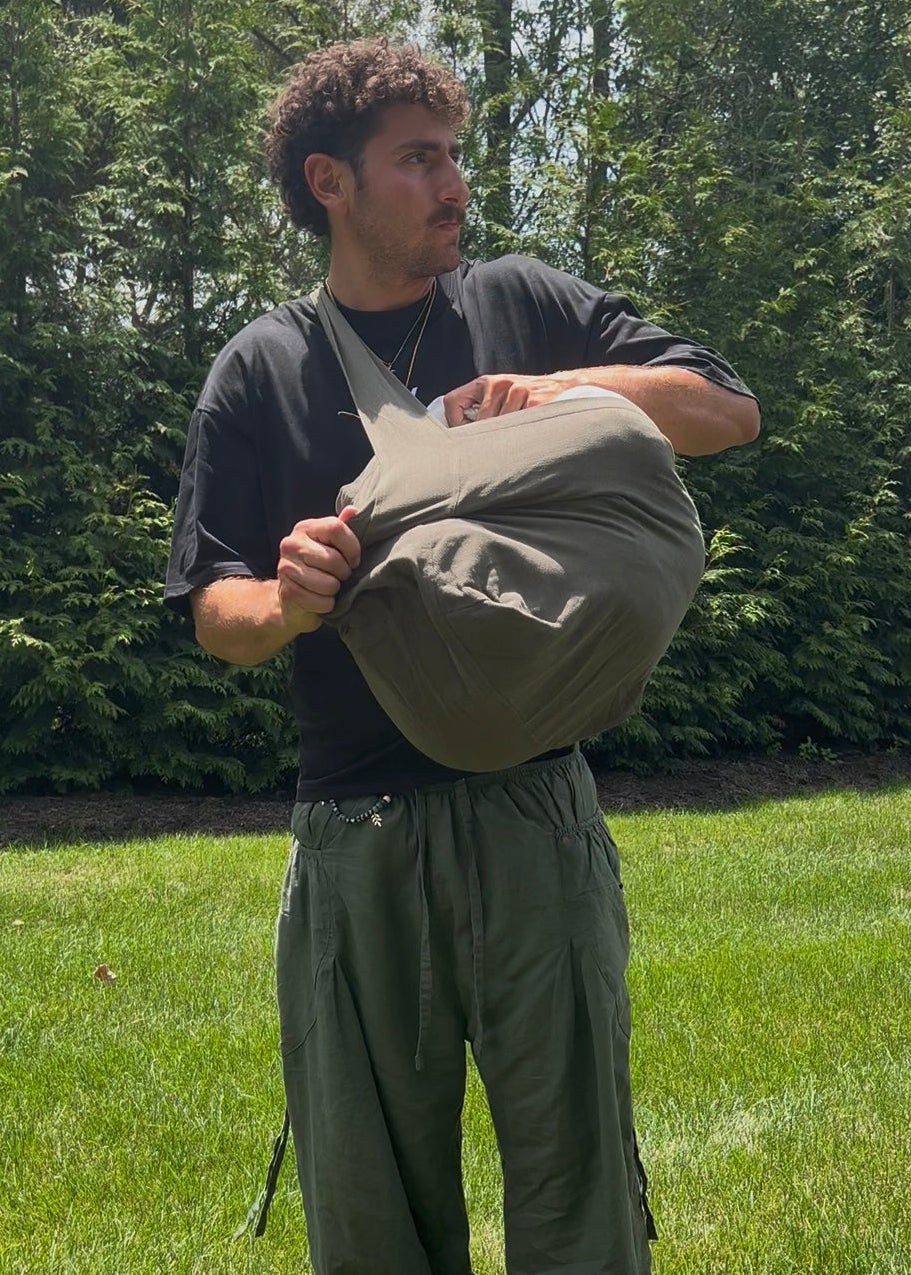 Bottomless Bag in Evergreen, stuffed full and held in both arms