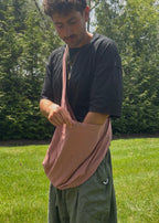 Bottomless Bag in Rosewood, worn crossbody